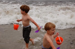 Cooper and Caden running from a wave